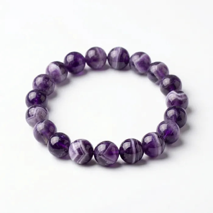 Amethyst jewelry bracelet with striped purple beads on white background, natural gemstone accessory for calm energy and elegant wear
