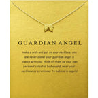 Angel wing necklace in gold shown on guardian angel meaning card, creating a meaningful symbolic jewelry gift for comfort and inspiration