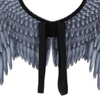 Angel wings closeup of black shoulder straps and gray feather texture in symmetrical wing layout.