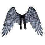 Angel wings with black straps and gray feathered plumage shown from rear flat-lay perspective.