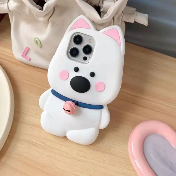 animal phone case featuring a white dog design with pink ears, a blue collar, and a pink bell.