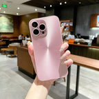 Light pink anti smudge iPhone case shown in hand with metallic texture and sleek camera cutout.