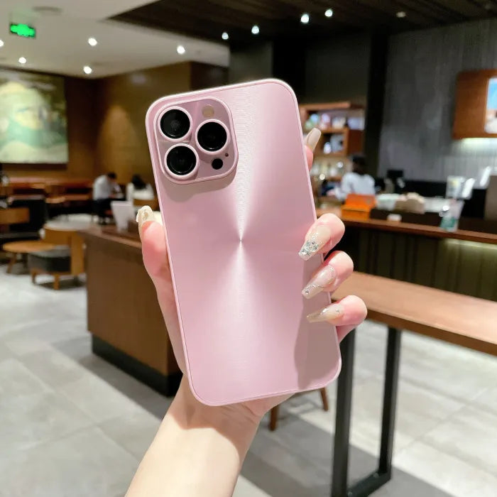 Light pink anti smudge iPhone case shown in hand with metallic texture and sleek camera cutout.