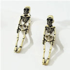 Antique-style gold skeleton earrings laid flat with full-body design and heart-shaped hip bones.