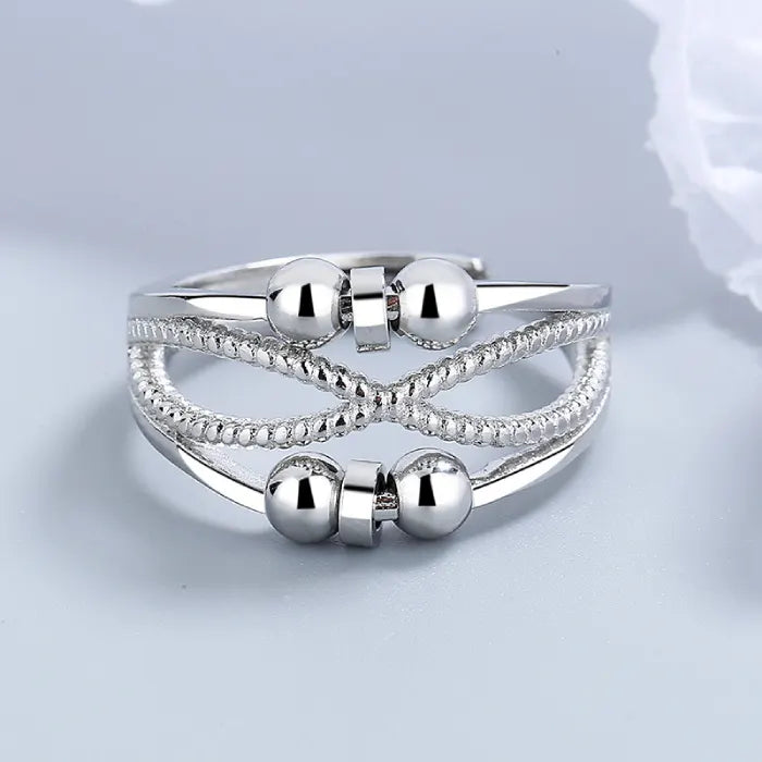 Anxiety relief ring with smooth spinning beads and detailed textured bands, offering stylish calming stress relief for everyday wear