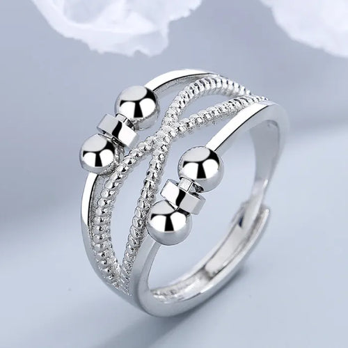 Anxiety relief ring with silver spinning beads and textured bands, offering calming fidget-friendly stress relief for daily soothing