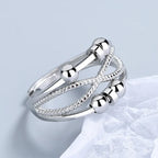 Anxiety relief ring featuring silver spinning beads and textured crossover bands, providing calming fidget support for stress relief use