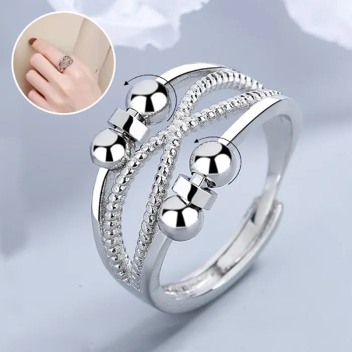 Anxiety relief ring with rotating beads and detailed silver bands, offering calming stress relief and stylish fidget-friendly soothing support