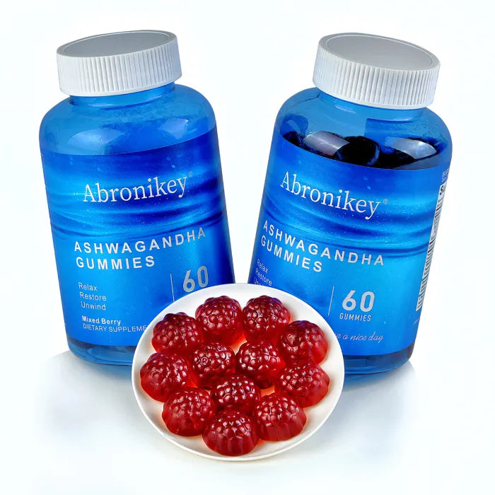 Two bottles of ashwagandha supplement gummies with serving size display of red berry-shaped gummies