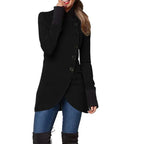 Black asymmetric wrap coat with curved hem and button closure, worn with jeans and over-the-knee boots.