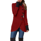 Asymmetric wrap coat in red with side buttons, long sleeves, and curved hem, styled with jeans and boots.