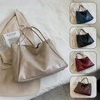 Autumn Shoulder bag in beige, navy, black, red, and brown displayed flat on bed and blazer