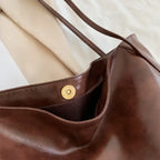 Autumn Shoulder bag magnetic snap button closure and inner pocket detail in brown leather