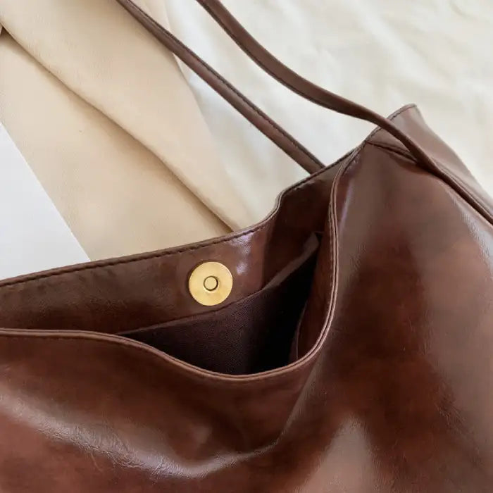 Autumn Shoulder bag magnetic snap button closure and inner pocket detail in brown leather