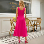 Rear view showing the flattering fit of the fuchsia sleeveless A-line midi dress with a scoop back. Buy this popular summer dress style with confidence and free shipping.