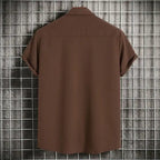 Back view of men's plus size casual short sleeve button-up shirt in brown hanging on grid wall.