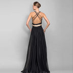 Rear view highlighting the intricate crisscross strap detail of the backless formal gown. Order this stunning black and cream two tone dress today for sophisticated style.