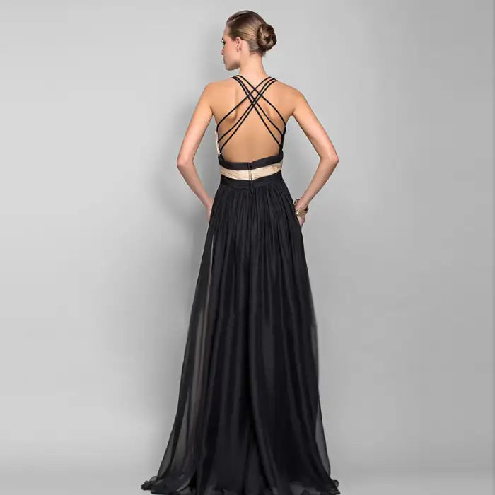 Rear view highlighting the intricate crisscross strap detail of the backless formal gown. Order this stunning black and cream two tone dress today for sophisticated style.