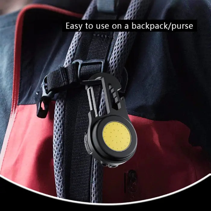  LED carabiner light attached to red and black backpack strap showing portable use