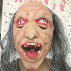 Bald gruesome costume mask with sharp red fangs and eerie pink eyes.
