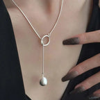 ball loop chain necklace silver loop design with long drop and round charm worn on chest