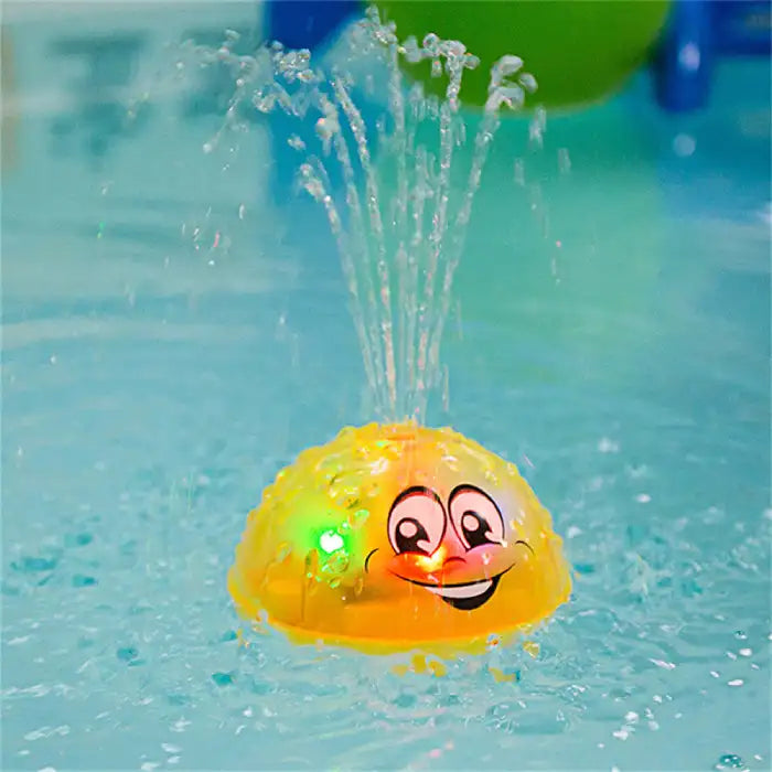 Bath toys shaped like a yellow dome with water-sprinkling LED lights, floating in the bath.