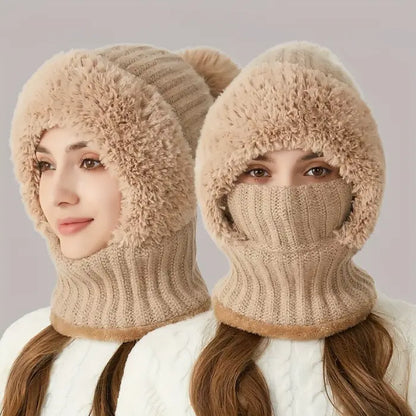 Woman wearing a beige cable knit balaclava style winter hat and mask scarf combination. 