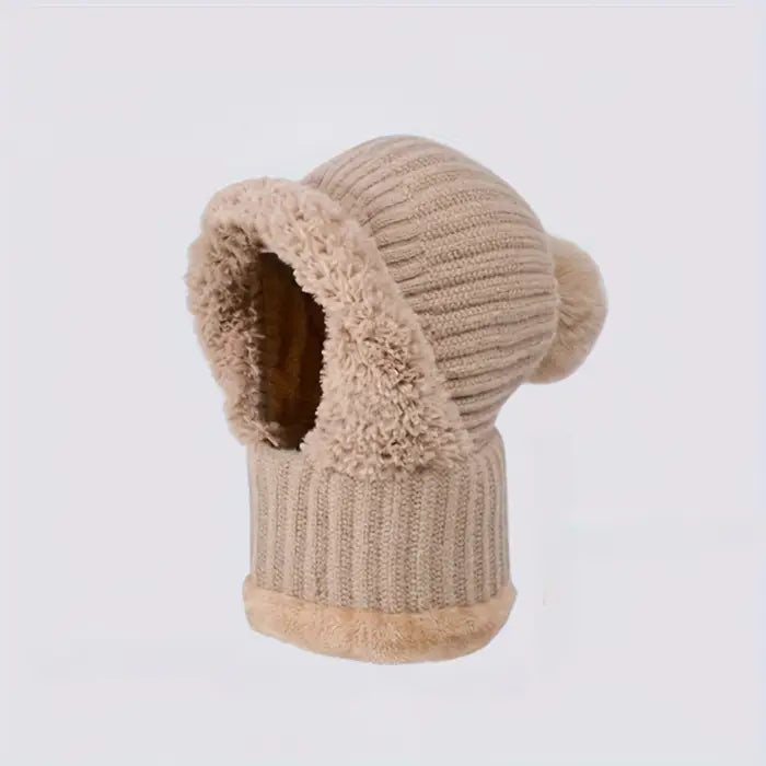 Beige knit hat with faux fur pom poms and ear flaps, shown on a white background