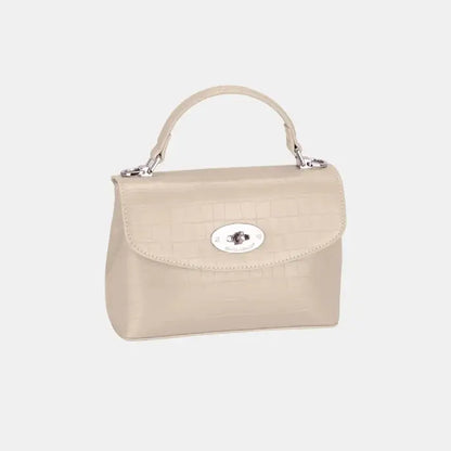 Beige crocodile-textured leather handbag with silver detailing, suitable for both casual and formal occasions.