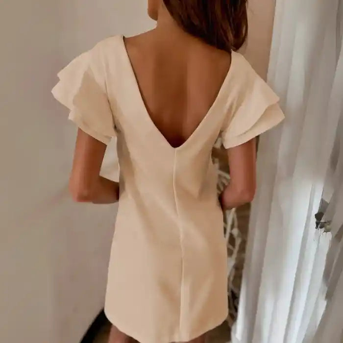 Beige ruffle sleeve shift dress back view shows deep v-back and soft fluttery sleeves.