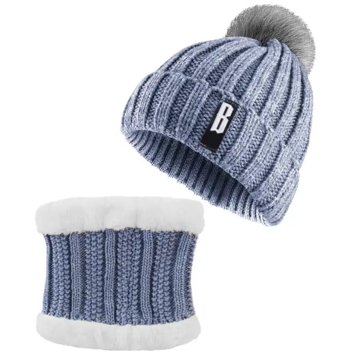 Blue Bennie Hat Scarf Set with gray pompom and white fleece lining for soft winter comfort.