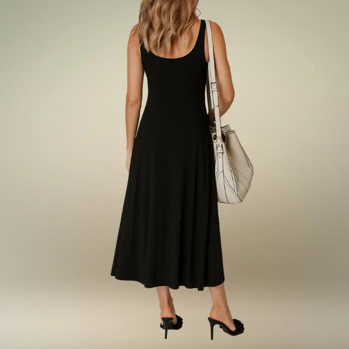 Back view of the timeless black sleeveless A-line midi dress, highlighting its simple scoop back design. Shop this versatile casual midi dress with slit for any occasion.