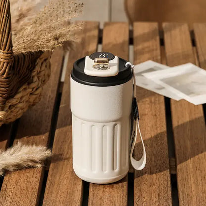 Black accented smart coffee mug on wooden surface with rustic background and dried plants