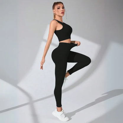 Black seamless workout set featuring crop top and high-waisted leggings with ribbed texture, styled with white athletic shoes