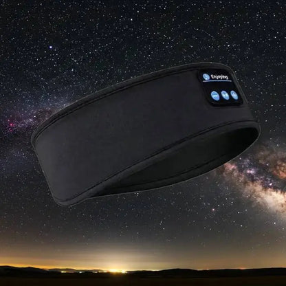 Bluetooth headband headphones displayed against a starry night sky for nighttime use.