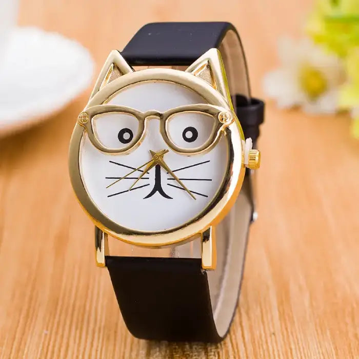 Sleek black strap wristwatch with a gold-tone cat-ear design and a white dial featuring a playful cat face.