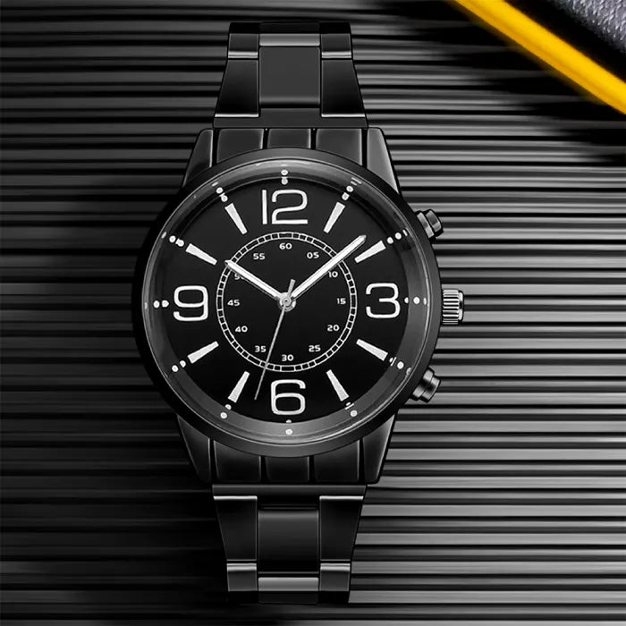 Sleek black chronograph timepiece with white markers on dark striped background showcasing modern minimalist style