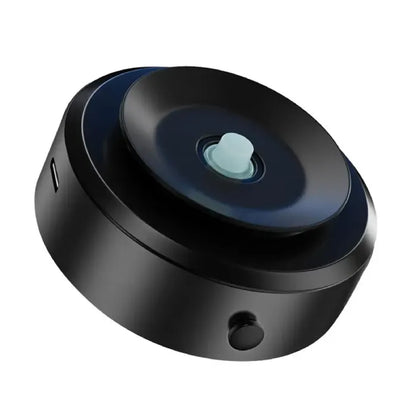 Close-up of black circular vacuum mount with blue center button, USB port, and side button against dark background