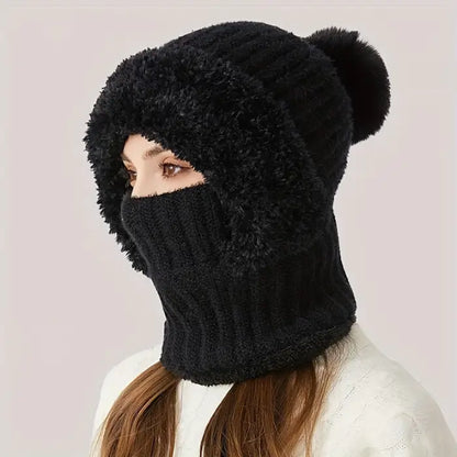 Woman wearing a black fluffy winter trapper hat with built-in balaclava face mask. 