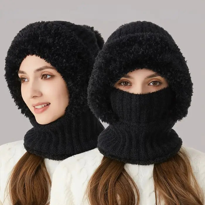 Two people wearing matching black fuzzy knit winter hats with connected face masks covering their nose and mouth 