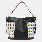 Versatile black leather bag with pastel geometric panels, burgundy trim, and studded strap detailing