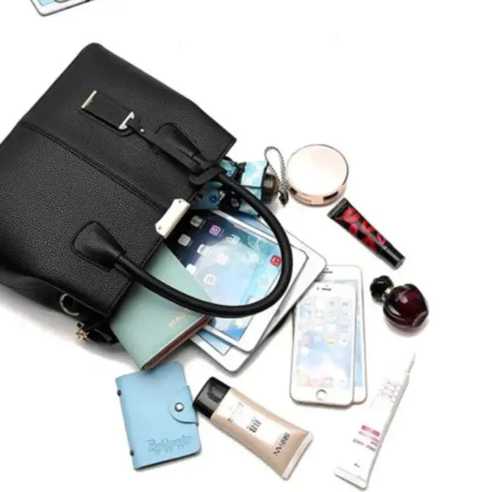 Black leather handbag with organized contents including phone, makeup, wallet, and tablet for daily use.