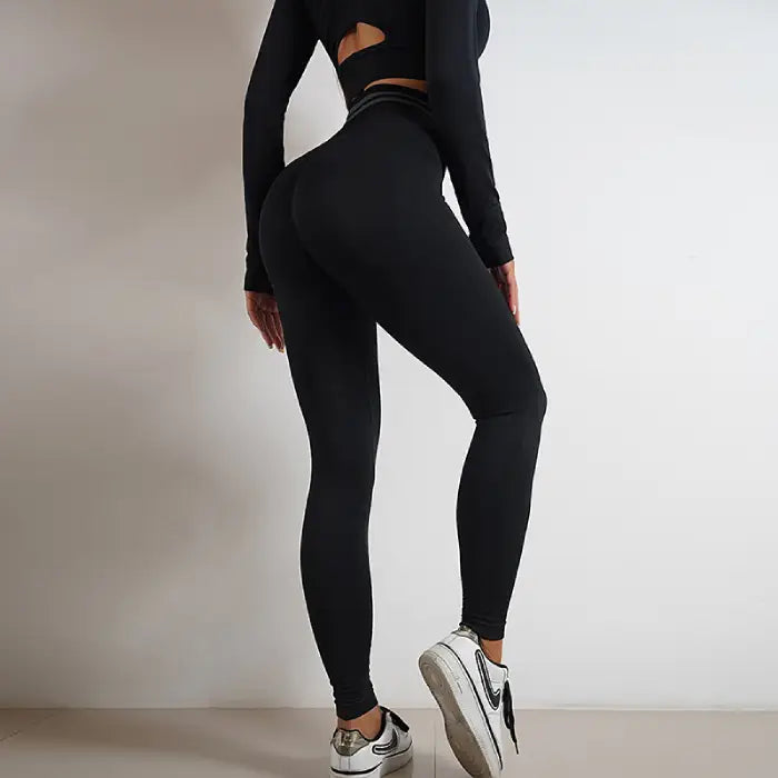 Seamless black activewear set with back cutout and high-waisted yoga leggings for women.