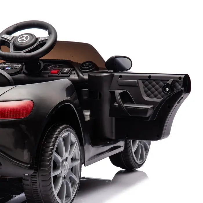 Side view of black kids' ride-on car with open door, highlighting interior and detailed craftsmanship.