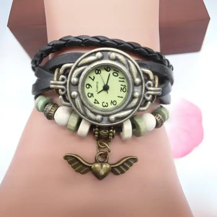 Black leather boho bracelet watch with heart charm and beads for casual women’s vintage fashion accessory.