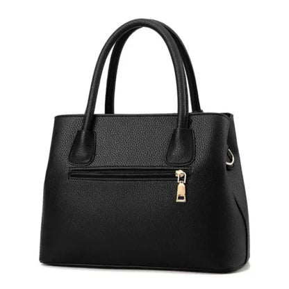 Black leather handbag with front pocket and gold zipper, ideal for stylish everyday use.