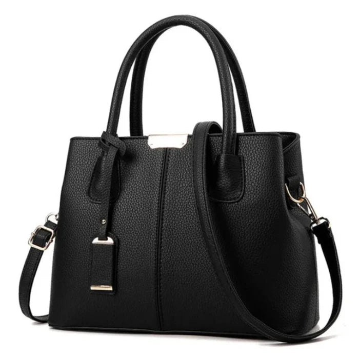 Classic black leather tote bag with gold hardware and adjustable strap for timeless style.