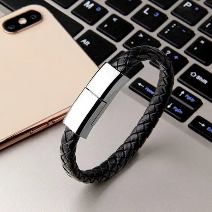 Black leather USB cable bracelet for charging and data syncing, compatible with various devices.