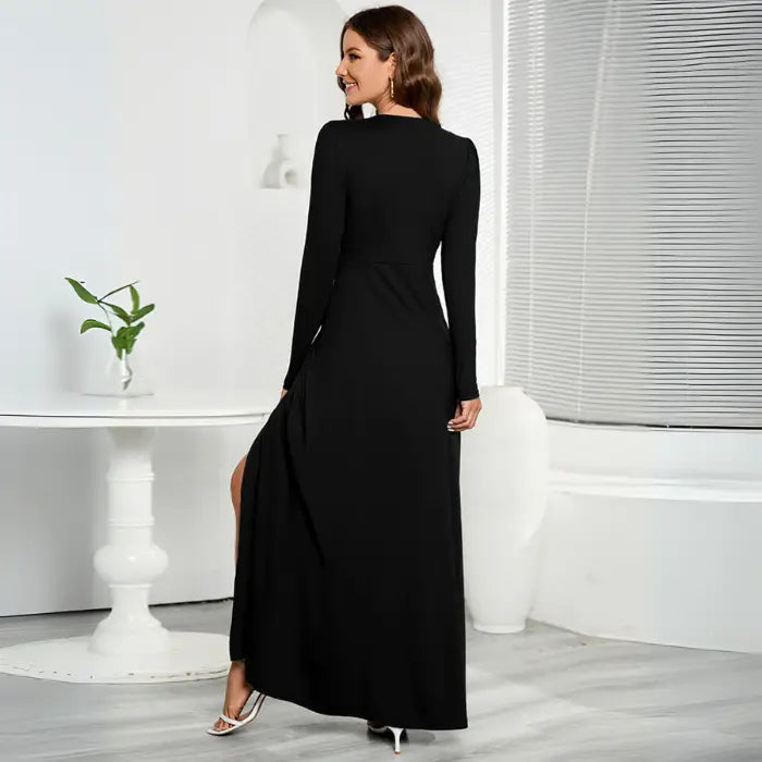 Black long sleeve V-neck maxi dress with a back view and a front slit design.