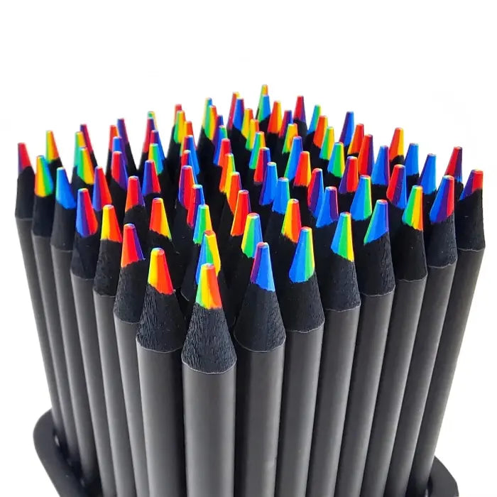 Close-up of black pencils with rainbow-colored tips arranged in a circular holder.